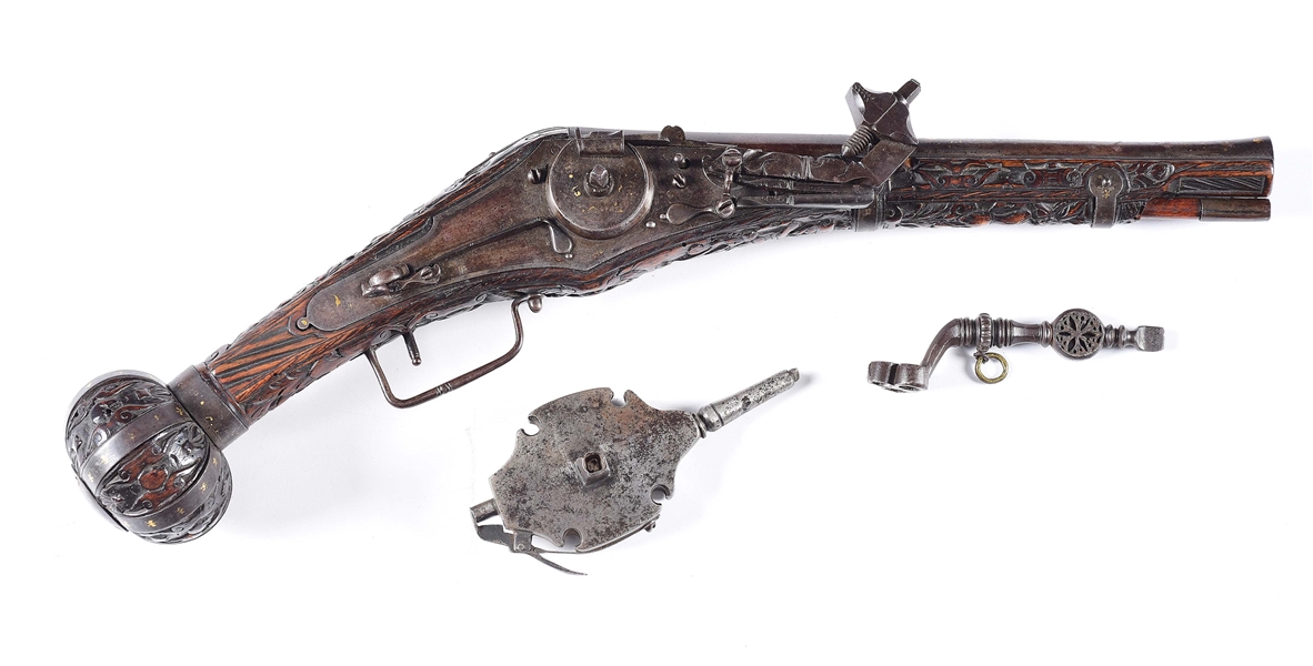 (A) HIGHLY ATTRACTIVE AND DEEPLY CARVED GERMAN WHEELOCK PISTOL WITH FLASK AND KEY, CIRCA LAST QUARTER OF THE 16TH CENTURY.