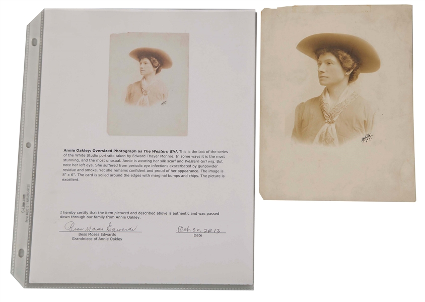 OVERSIZED SIGNED PHOTOGRAPH OF ANNIE OAKLEY AS THE WESTERN GIRL, ACCOMPANIED BY A SHOT 1890 HALF PENNY.