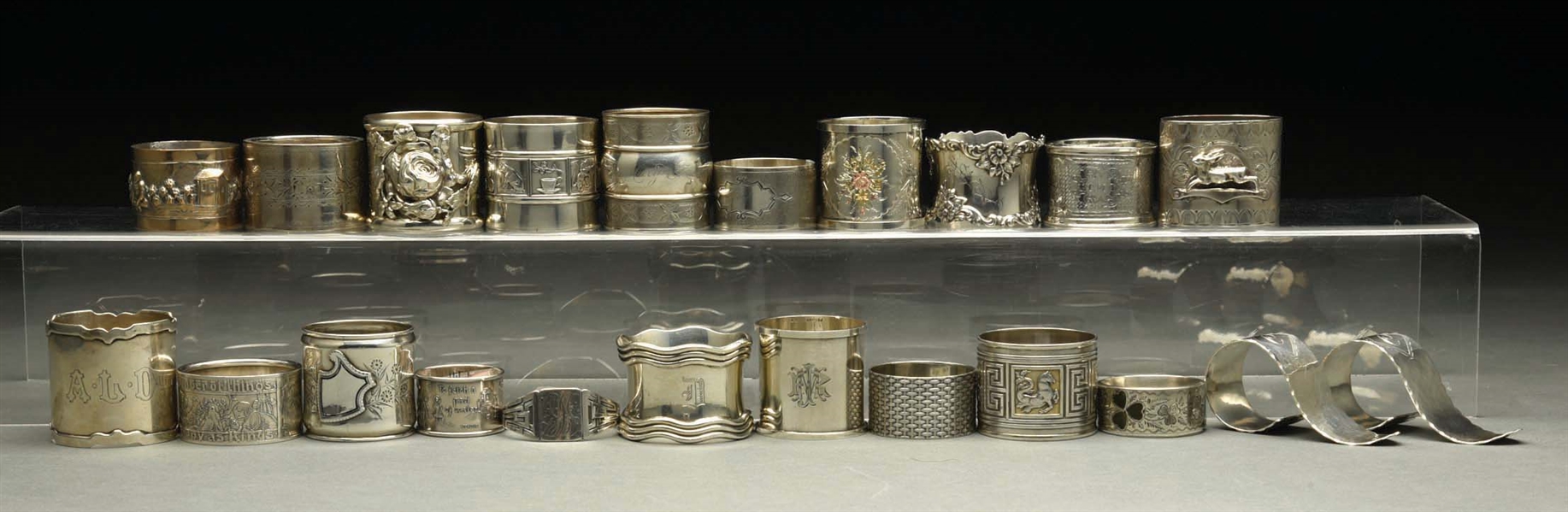 LOT OF 22: STERLING SILVER NAPKIN RINGS. 