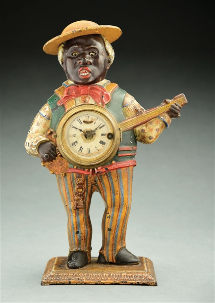 CAST-IRON BLACK AMERICANA MUSICIAN SAMBO BANJO PLAYER BLINKING EYE CLOCK.