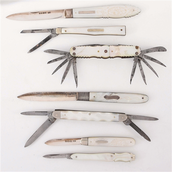 LOT OF 7: FANCY EARLY CARVED AND DECORATED M.O.P. FOLDING KNIVES.