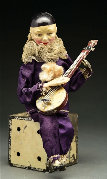 GERMAN HAND-PAINTED AND CELLULOID CLOWN PLAYING BANJO TOY.