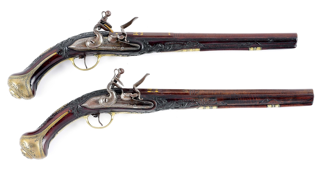 (A) LOT OF 2: A PAIR OF FLINTLOCK HOLSTER PISTOLS WITH ATTRACTIVE RELIEF CARVED STOCKS, POSSIBLY MEDITERRANEAN.