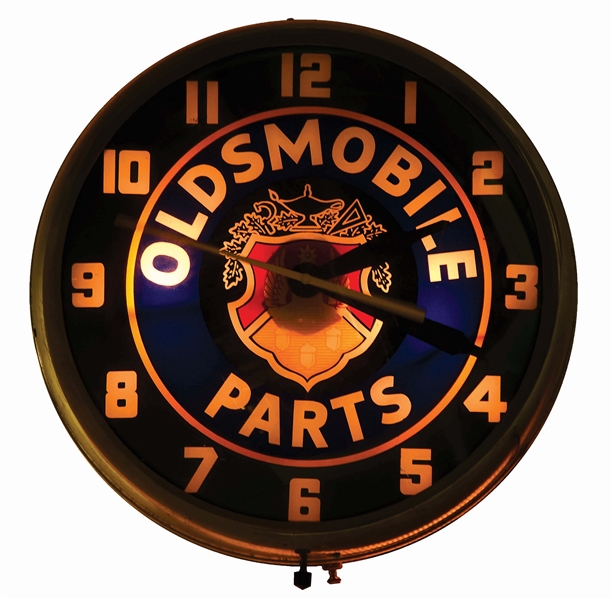 OLDSMOBILE PARTS GLASS FACE LIGHT UP CLOCK W/ CREST GRAPHIC.