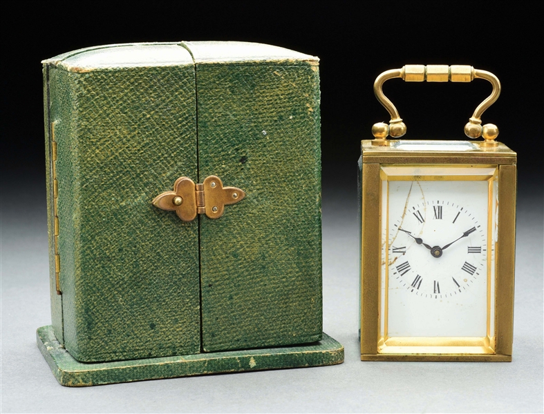 CARRIAGE CLOCK WITH HINGED GREEN LEATHER CASE.