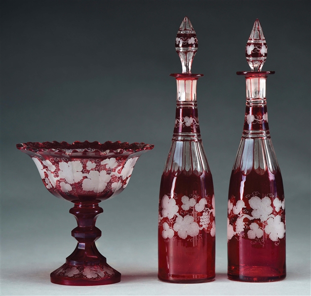 3 PIECE CRANBERRY CUT TO CLEAR DECANTERS AND BOWL.