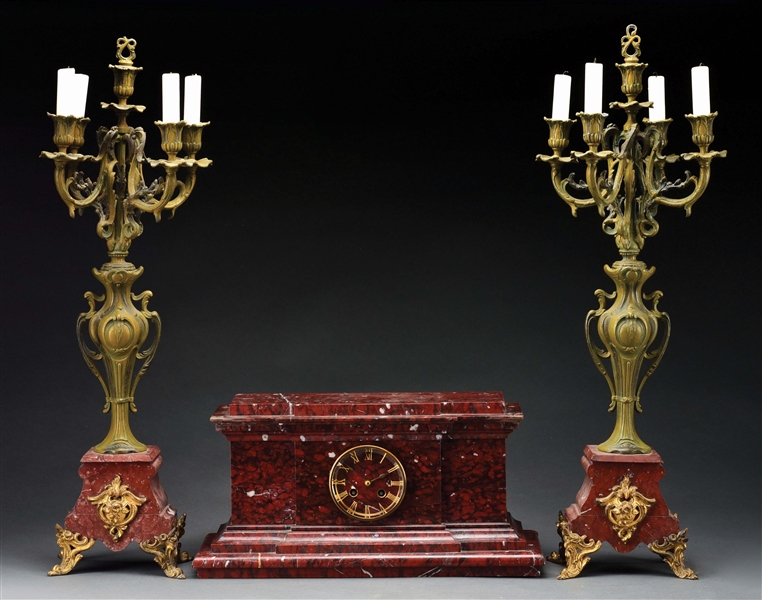 RED MARBLE THREE PIECE CLOCK AND CANDELABRA SET.