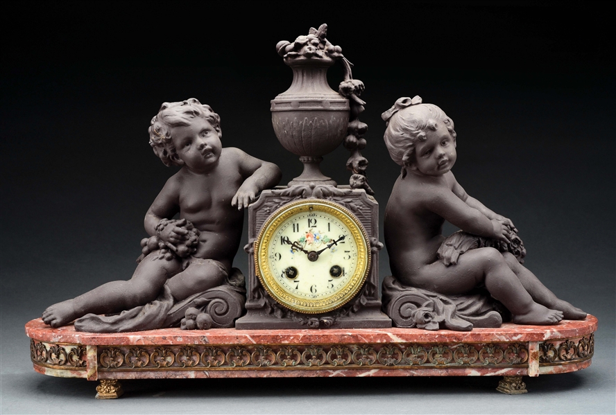 FRENCH PATINATED METAL AND MARBLE CHERUB CLOCK.