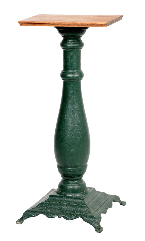 CAST-IRON SLOT MACHINE STAND IN ADDED GREEN PAINT.
