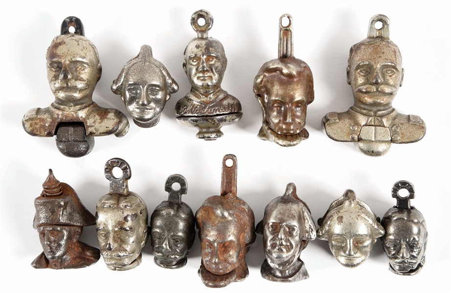 LOT OF 12: EARLY FIGURAL CAST-IRON CAP BOMBS.