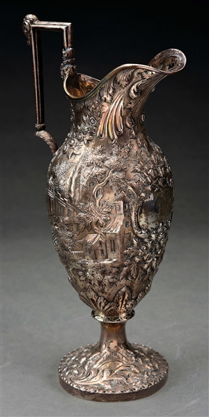 AN AMERICAN REPOUSSE SILVER PITCHER.