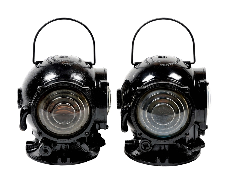PAIR OF PYLE-NATIONAL CAST-IRON CANNONBALL LOCOMOTIVE CLASSIFICATION LAMPS.