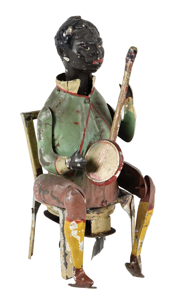 EARLY GERMAN HAND PAINTED WINDUP AFRICAN AMERICAN BANJO PLAYER TOY.