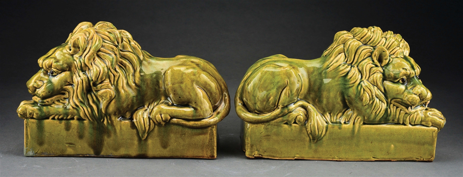 PAIR OF GREEN GLAZED LIONS.