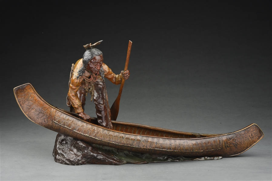 NATIVE AMERICAN INDIAN STEPPING INTO A CANOE BRONZE SCULPTURE.