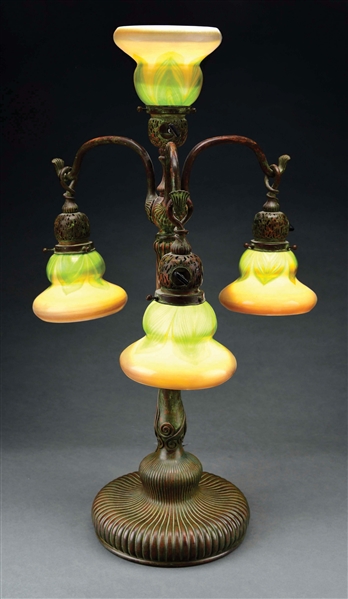 TIFFANY STUDIOS NEWELL POST 4-LIGHT FAVRILE GLASS AND BRONZE LAMP.