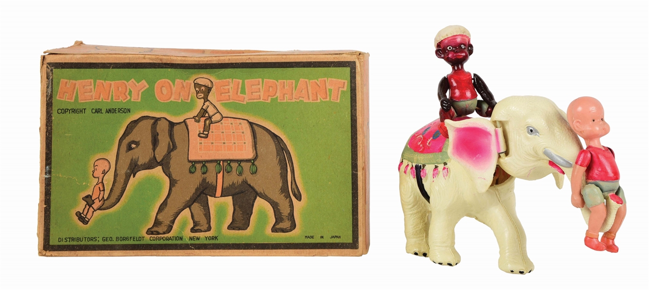 JAPANESE PRE-WAR WIND-UP CELLULOID HENRY ON ELEPHANT TOY.