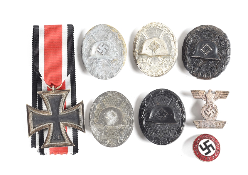LOT OF 8: THIRD REICH IRON CROSS, IRON CROSS CLASP, WOUND BADGES, AND PARTY PIN. 