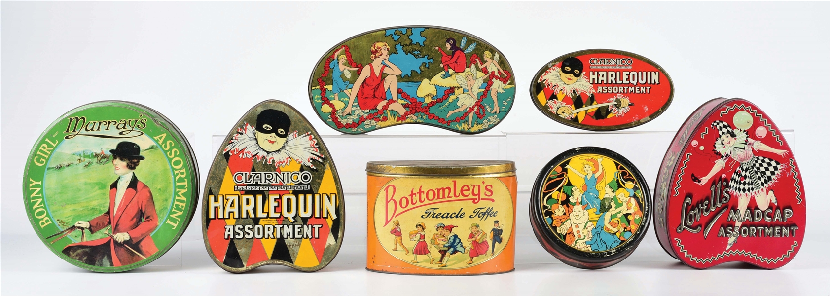LOT OF 7: ENGLISH CANDY TINS.