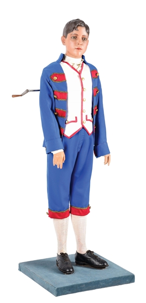 LIFE SIZE YOUNG BOY DRESSED IN MAJORETTE OR BAND COSTUME.