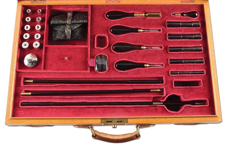 ENGLISH OAK AND LEATHER TOOL KIT INCLUDING CLEANING TOOLS, CHAMBER GAUGES, SNAP CAPS.
