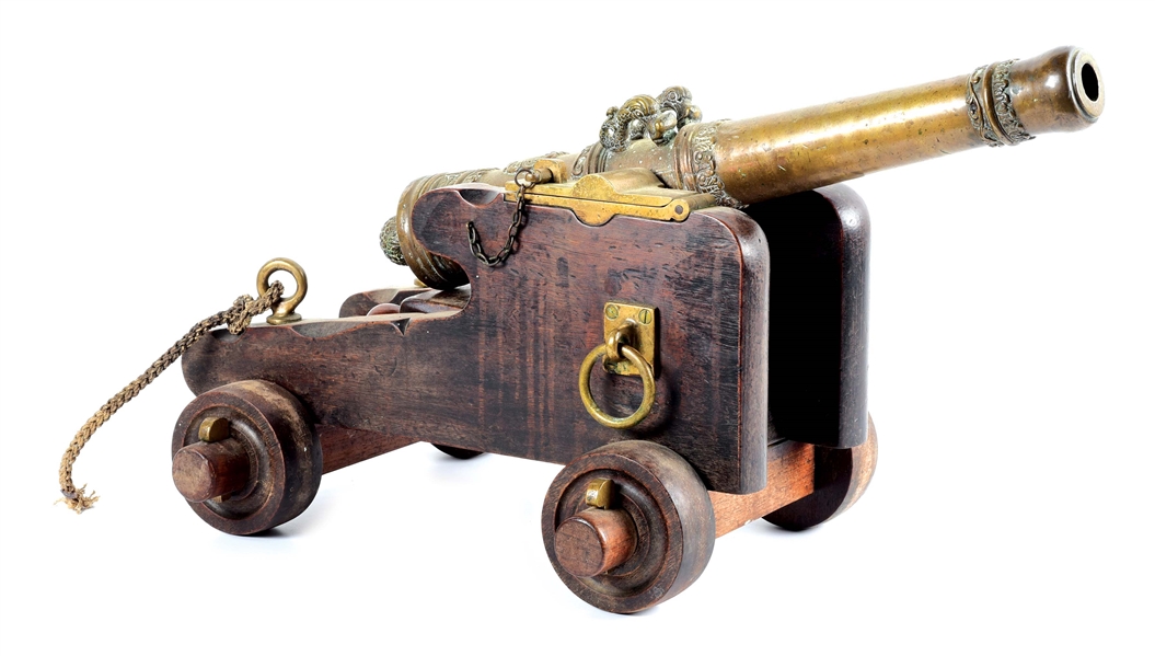 AN ATTRACTIVE, ELABORATELY CAST, BRONZE CANNON ON CARRIAGE.