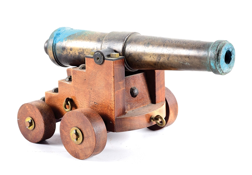 SMALL BRASS SIGNAL CANNON WITH CARRIAGE.