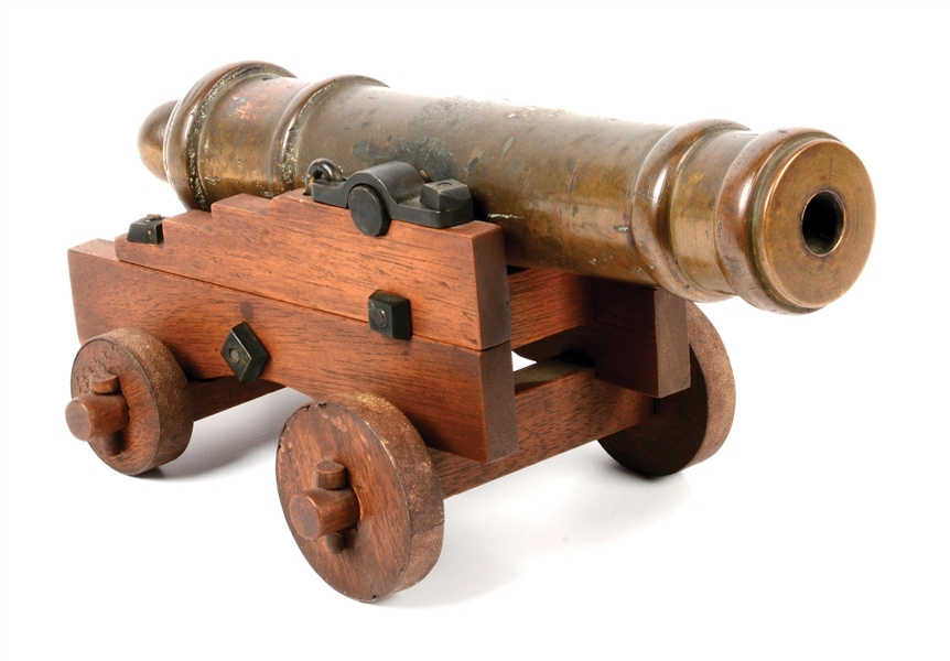 ATTRACTIVE SMALL BRASS SIGNAL CANNON ON WOOD CARRIAGE.