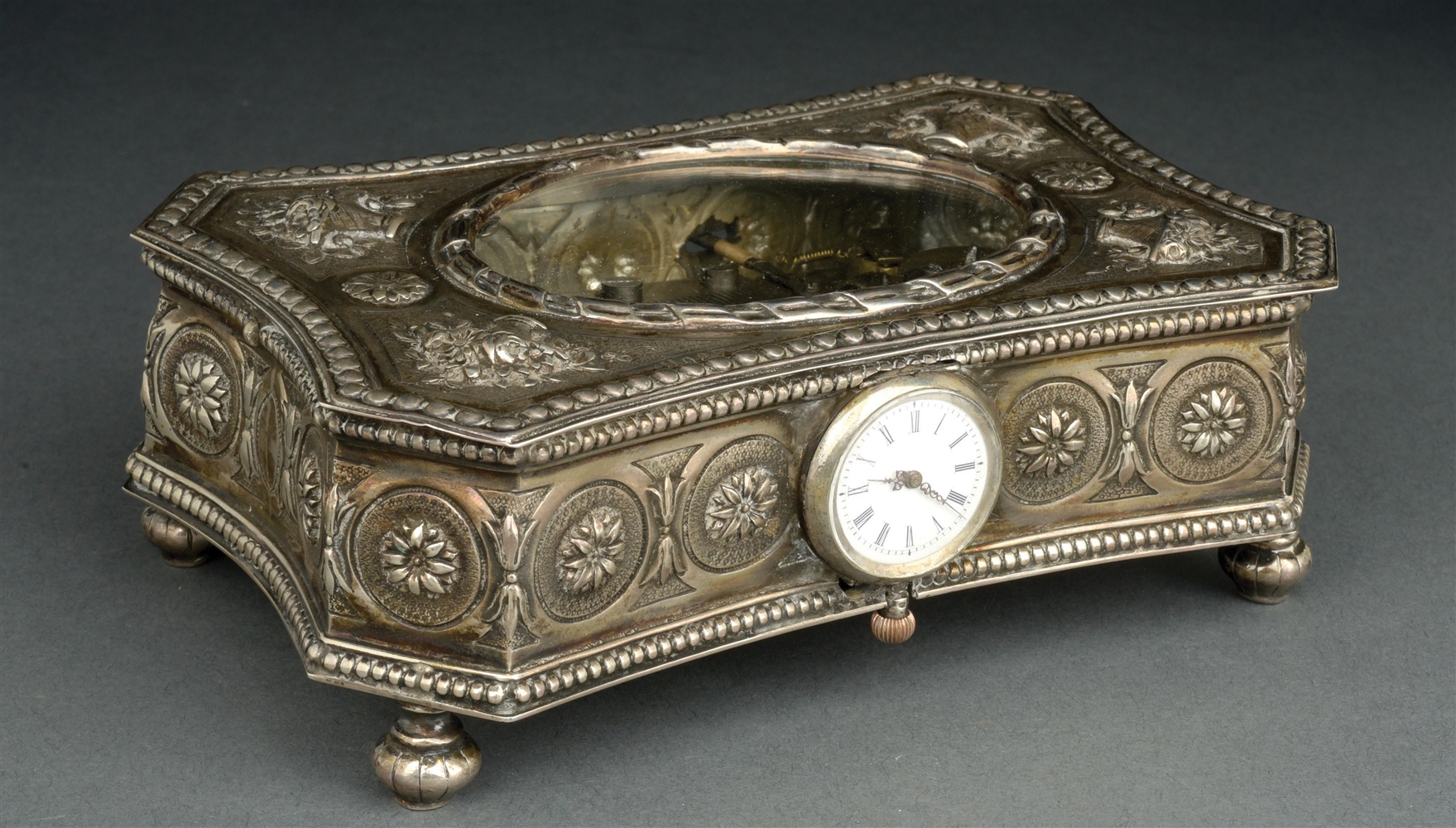 ELABORATE REPOUSSE MUSIC BOX WITH CLOCK.