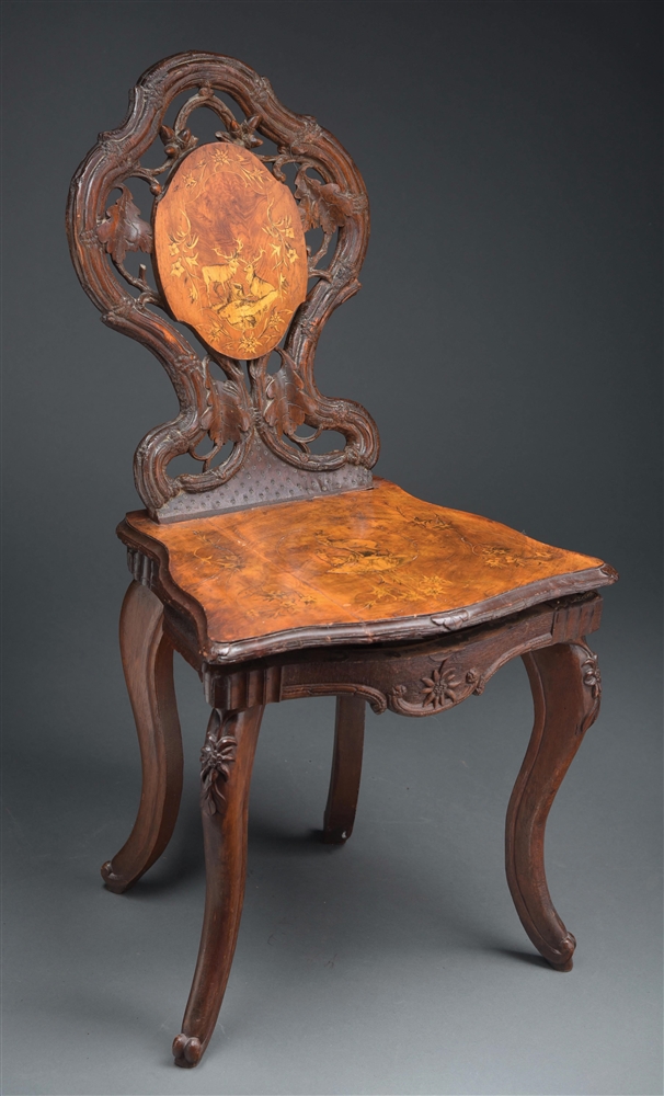 HIGHLY CARVED MUSICAL ADULT SIZED CHAIR.