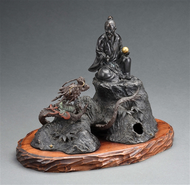 BRONZE FIGURAL ASIAN MAN AND DRAGON STATUE CALL BELL ON WOOD BASE.