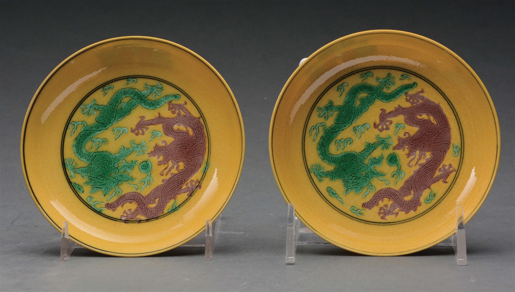 PAIR OF CHINESE YELLOW GLAZE DRAGON DISHES.