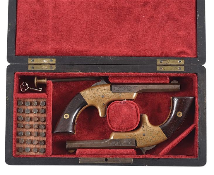 (A) MATCHING PAIR OF ENGRAVED H.C. LOMBARD CO. SINGLE SHOT PISTOLS WITH CASE.