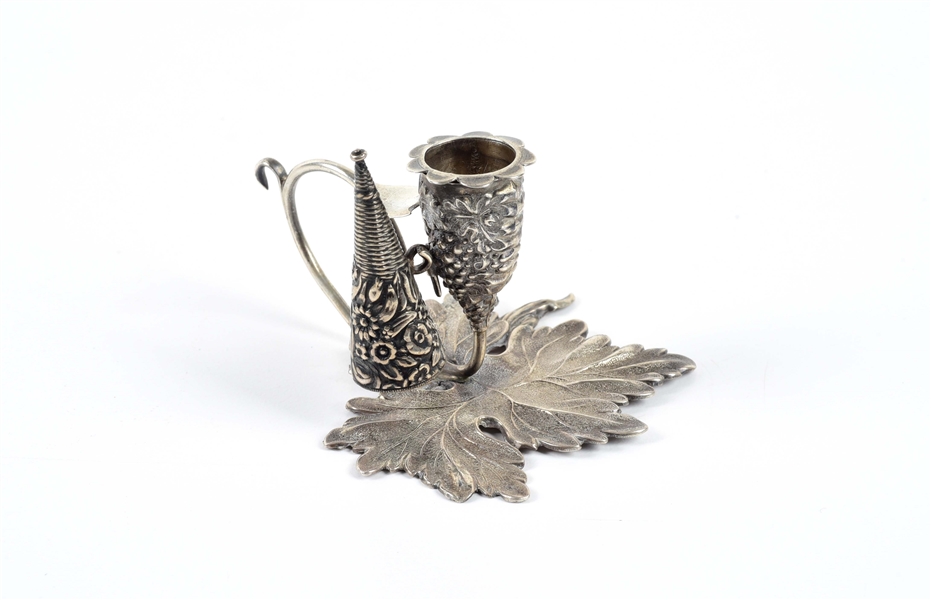 STERLING SILVER MINIATURE CANDLE SNUFFER ON LEAF BASE.