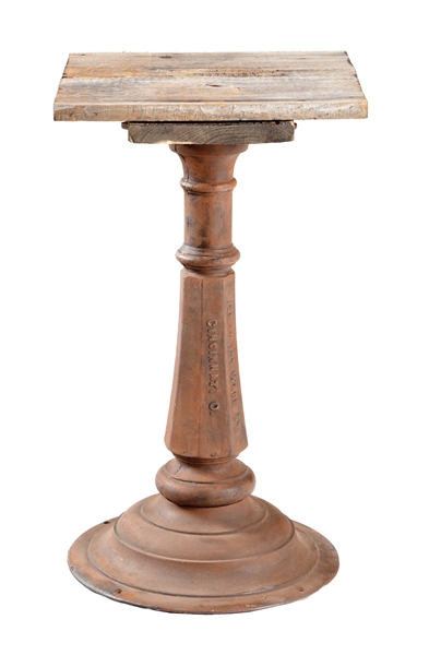 CAST IRON SLOT MACHINE STAND WITH ADDED WOODEN TOP.