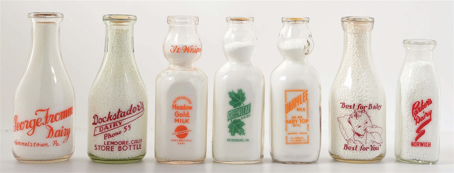 COLLECTION OF 7 VARIOUS MILK JARS.