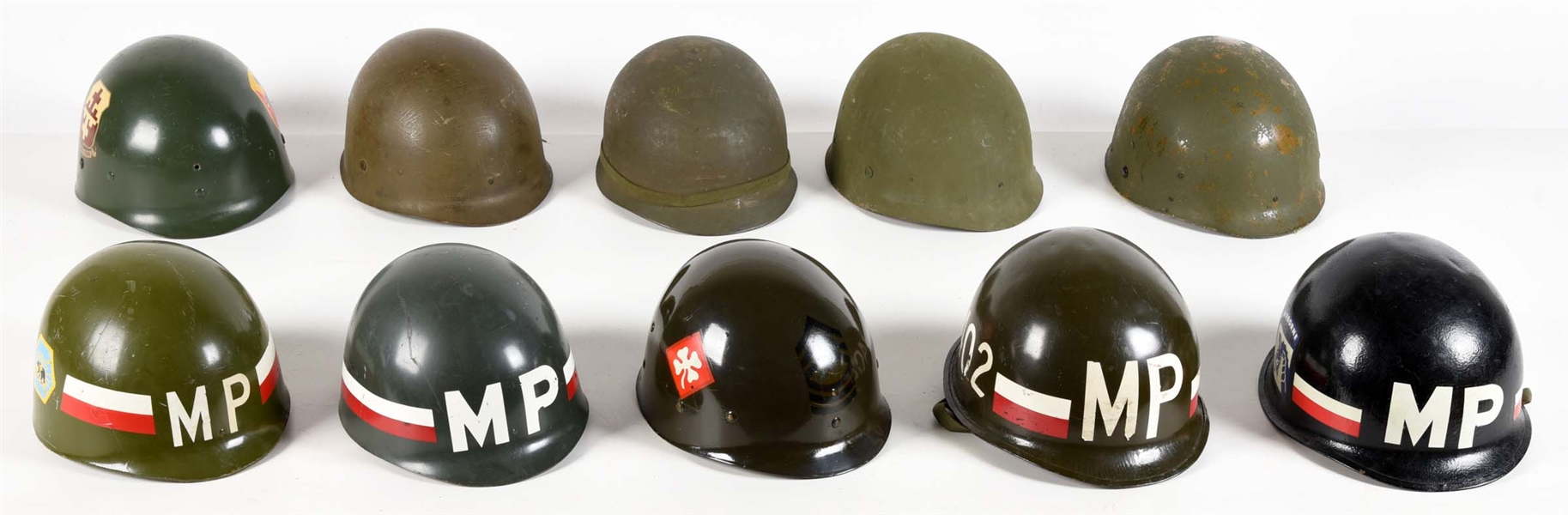 LOT OF US ARMY HELMETS AND PAINTED HELMET LINERS.