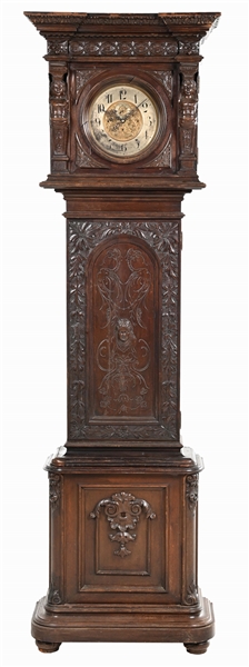 CARVED MAHOGANY GRANDFATHER CLOCK WITH BRASS DIAL.