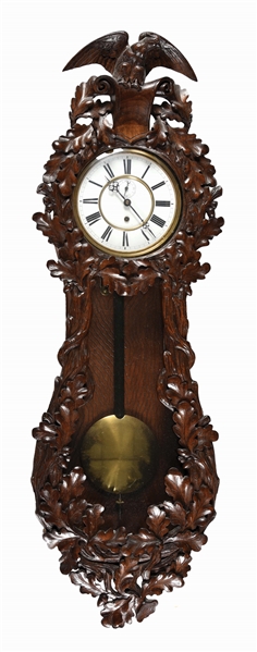 CARVED WOOD OAK LEAF MOTIF WALL CLOCK WITH ROMAN NUMERALS FACE.