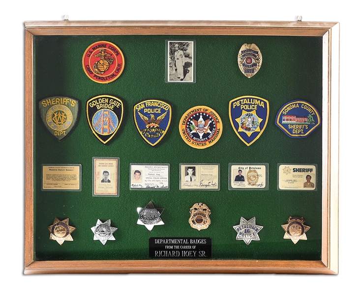 FRAMED DISPLAY OF POLICE BADGES FROM THE CAREER OF RICHARD HOEY.