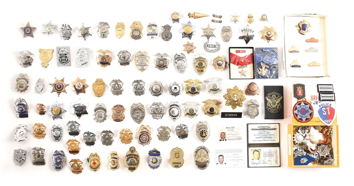 LOT OF VINTAGE POLICE BADGES AND HAT INSIGNIA.