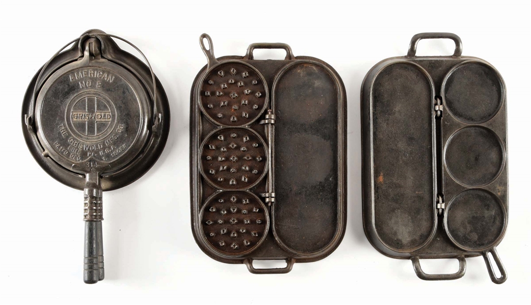 CAST IRON GRISWOLD WAFFLE IRON AND PAIR OF PANCAKE GRIDDLES.