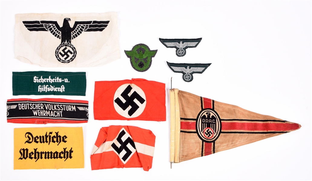 LOT OF THIRD REICH ARMBANDS, SHIRT EAGLE, PENNANT, AND OTHER INSIGNIA.