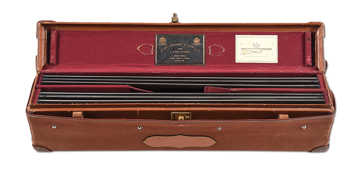 (A) PAIR OF JAMES PURDEY & SONS 12 GAUGE BAR-IN-WOOD SIDE BY SIDE HAMMER GUNS IN MOTOR CASE.