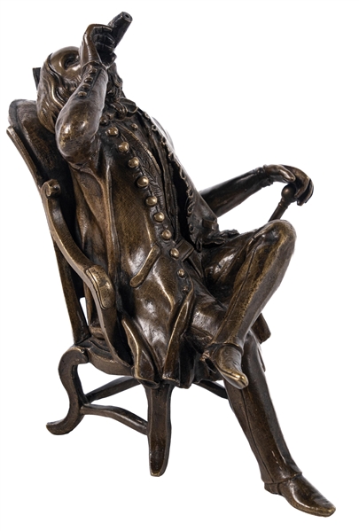 BRASS SCULPTED FIGURAL CIGAR LIGHTER IN THE FORM OF A MAN MONLEY SITTING IN A CHAIR