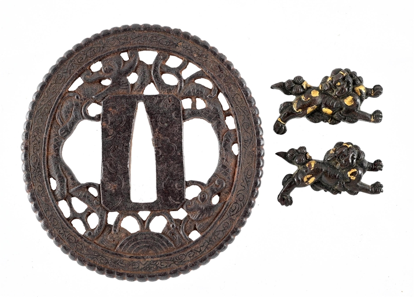 LOT OF TWO: TSUBA WITH SILVER INLAY AND PIERCED DESIGN OF DRAGONS, AND MENUKI IN THE FORM OF SHI-SHI DOGS.