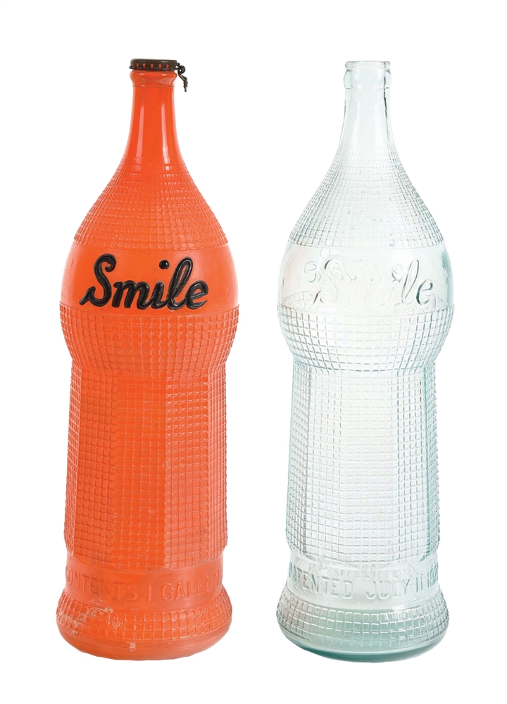 PAIR OF ORANGE SMILE SYRUP BOTTLES