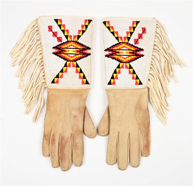 PAIR OF NATIVE AMERICAN BEADED GEOMETRIC PATTERNED GAUNTLETS.