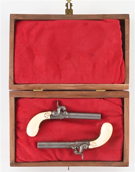 (A) CASED SET OF ENGRAVED BELGIAN IVORY HANDLE MUFF PISTOLS.