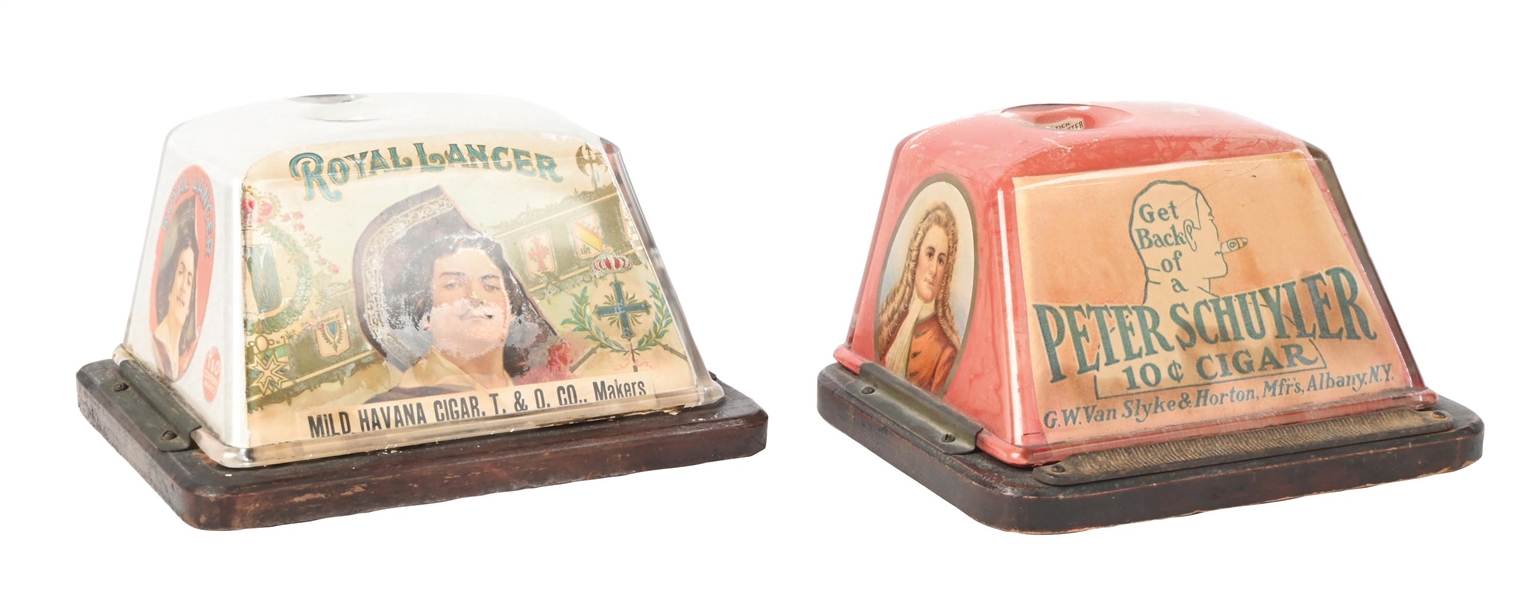 A PAIR OF COUNTERTOP CLOCKWORK GLASS ADVERTISING CIGAR CUTTERS